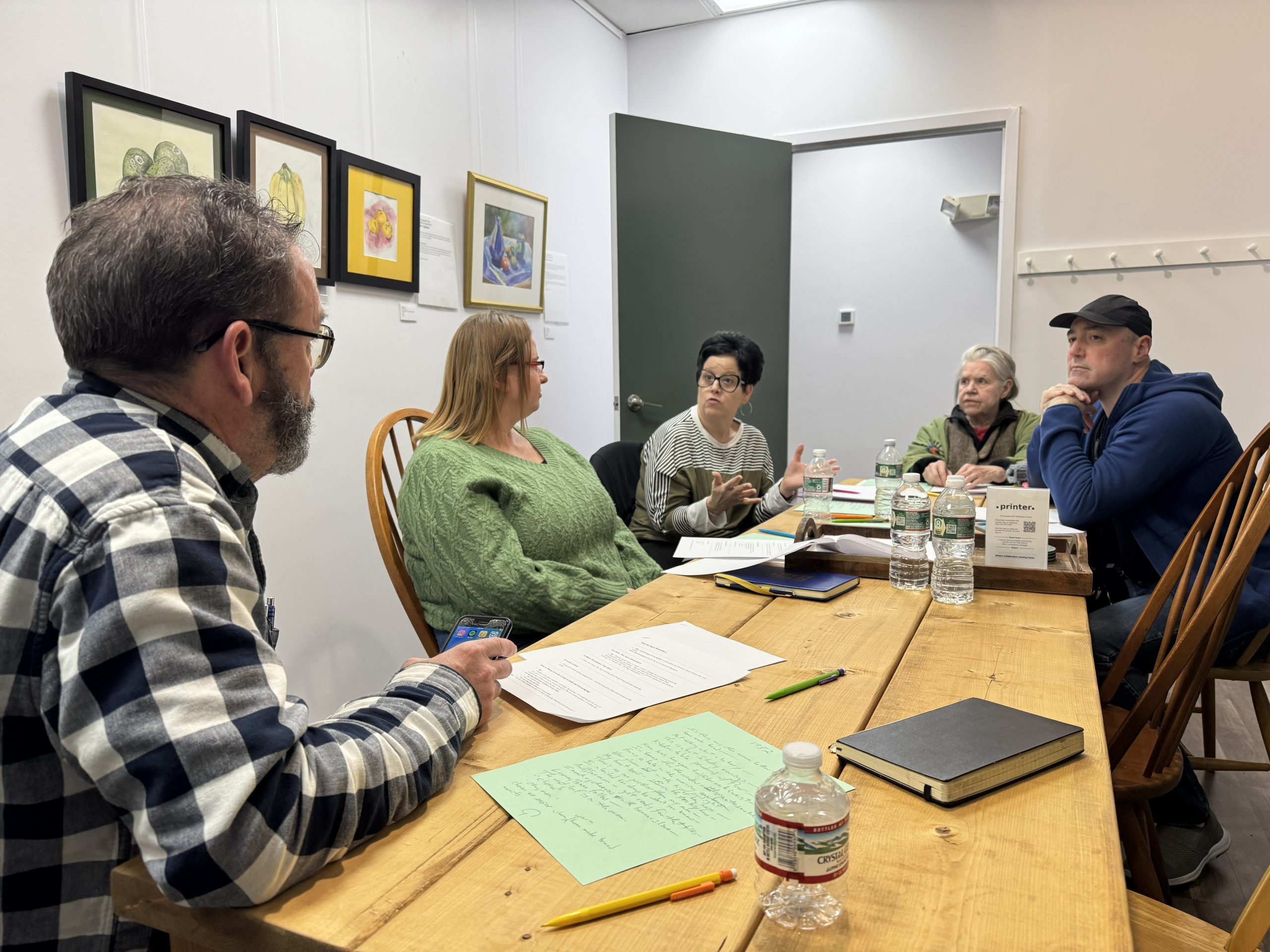 Writers in discussion around a table at WCLC